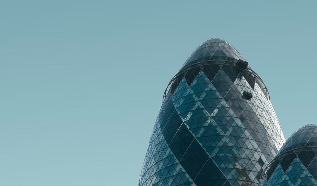 Modern glass skyscraper against sky