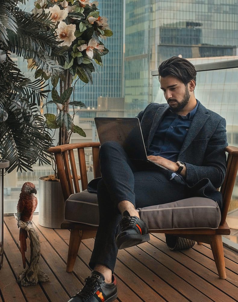 Man working on laptop in stylish setting.