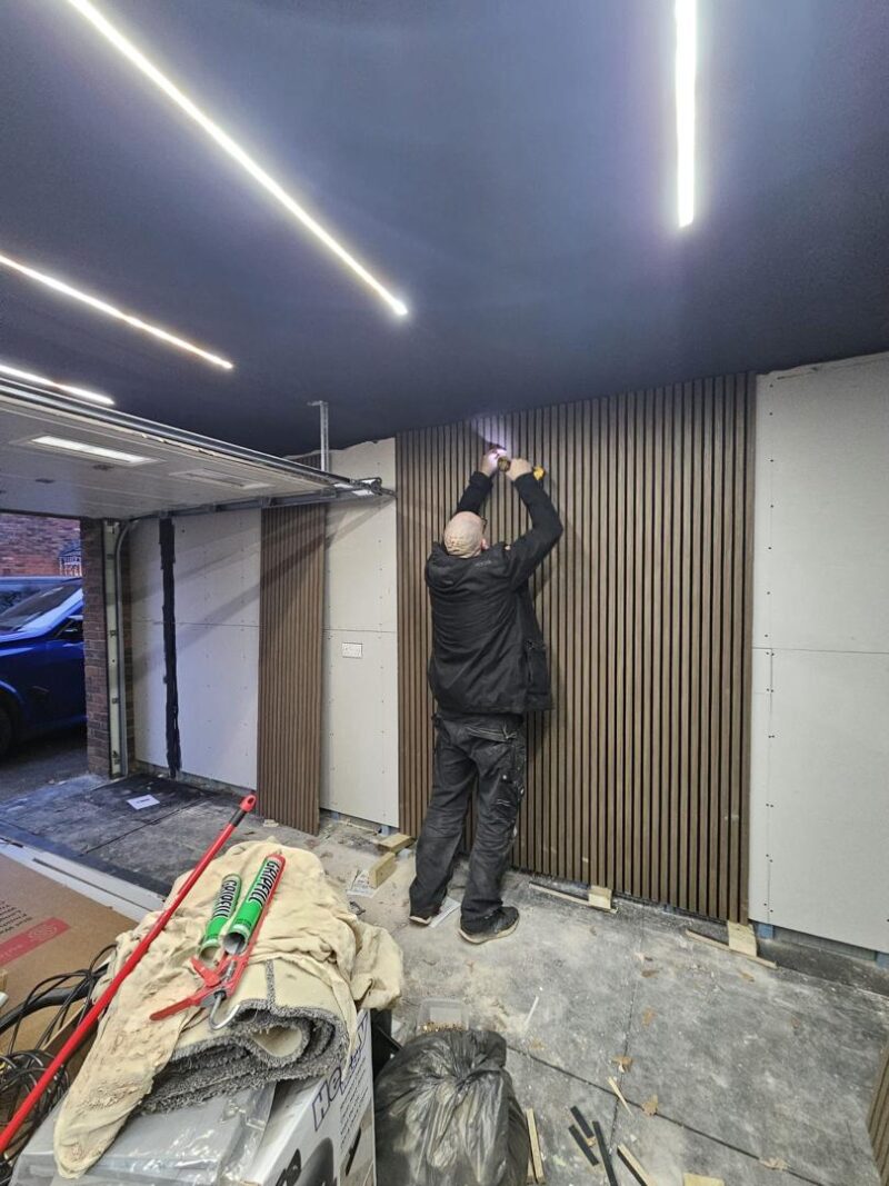 Team in action — coordinating seamlessly to keep the project moving 17 Man installing wooden wall panels